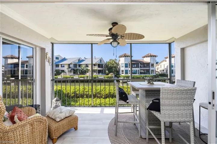 The screened balcony features a ceiling fan, providing comfort for outdoor living