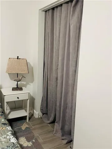 Bedroom featuring wood finished floors and baseboards