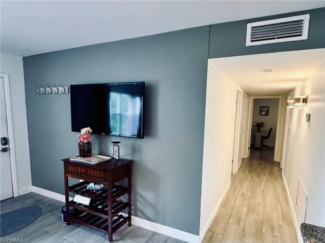 Laundry room featuring washing machine and dryer and light wood-style floors