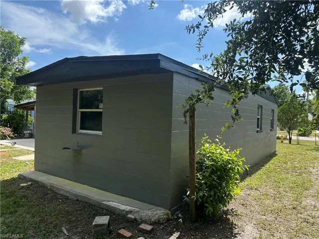 View of side of home featuring concrete block siding