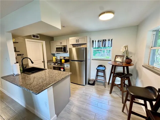 Kitchen featuring light stone counters