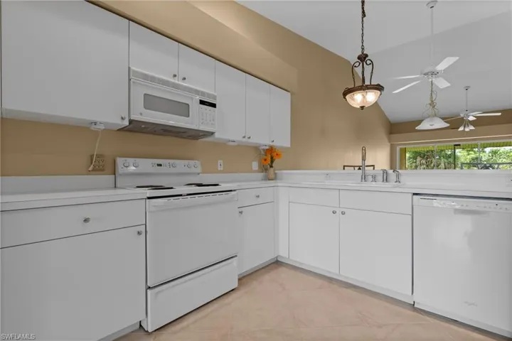 Kitchen featuring white cabinetry, white countertops, built-in microwave, electric range, and dishwasher