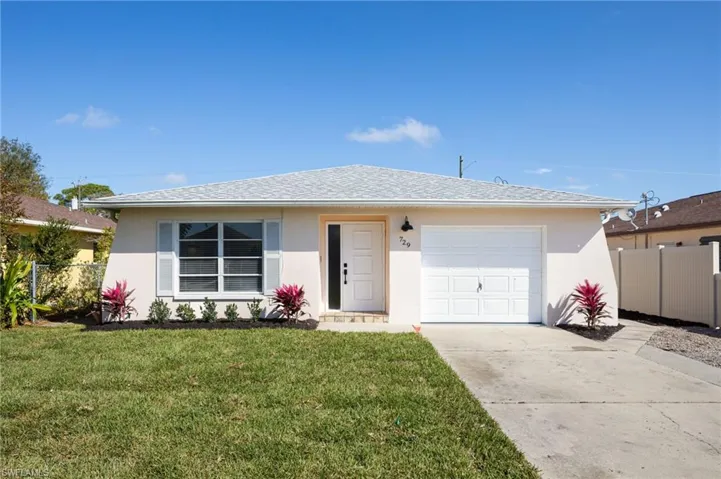 Ranch-style house featuring stucco siding, new landscaping and irrigation system, a one car garage, and a shingled roof only 5 yrs old.