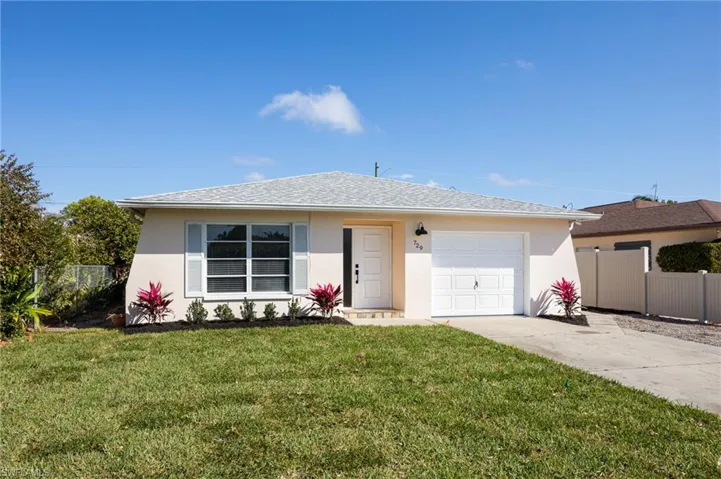 Ranch-style home featuring stucco siding, an attached garage, concrete driveway, and roof with shingles