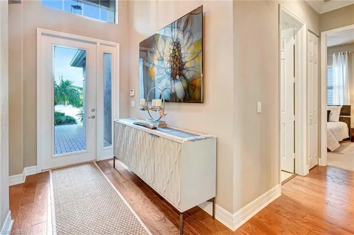 Entryway featuring ornamental molding and light hardwood / wood-style flooring