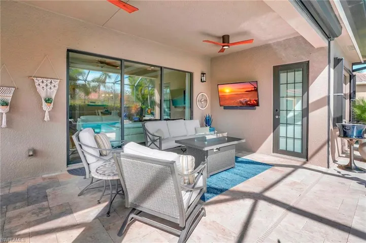 View of patio with outdoor lounge area and ceiling fan