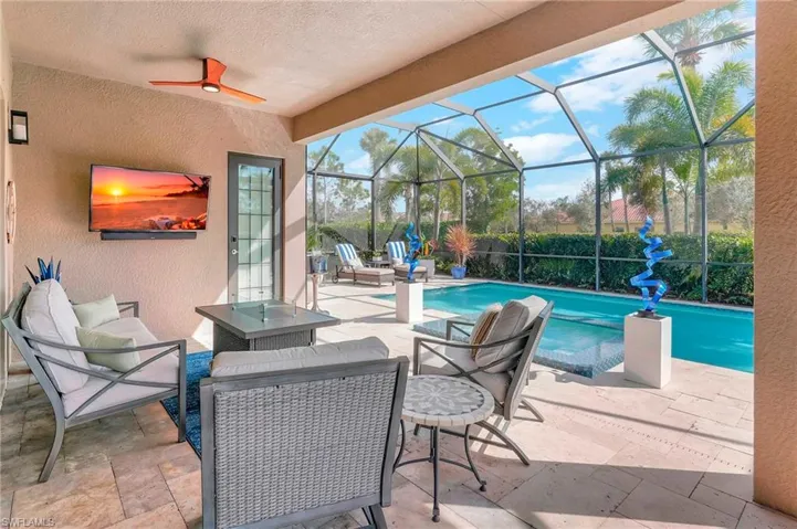 View of swimming pool featuring a patio area and glass enclosure