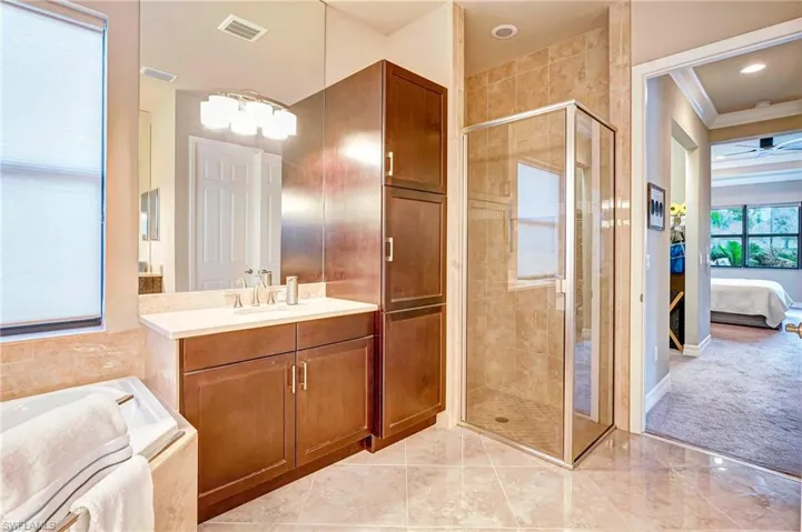 Main Bathroom featuring vanity, an enclosed shower, and crown molding