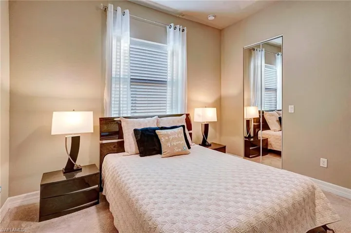 Bedroom featuring light colored carpet