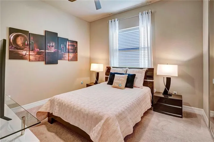 Carpeted bedroom with ceiling fan