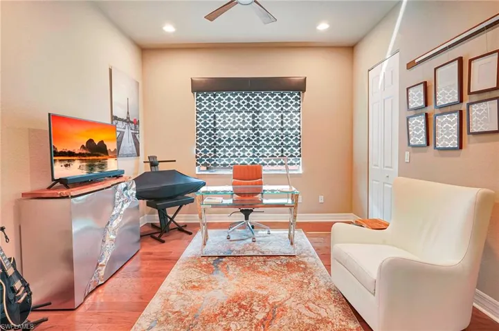 Office space with ceiling fan and wood-type flooring