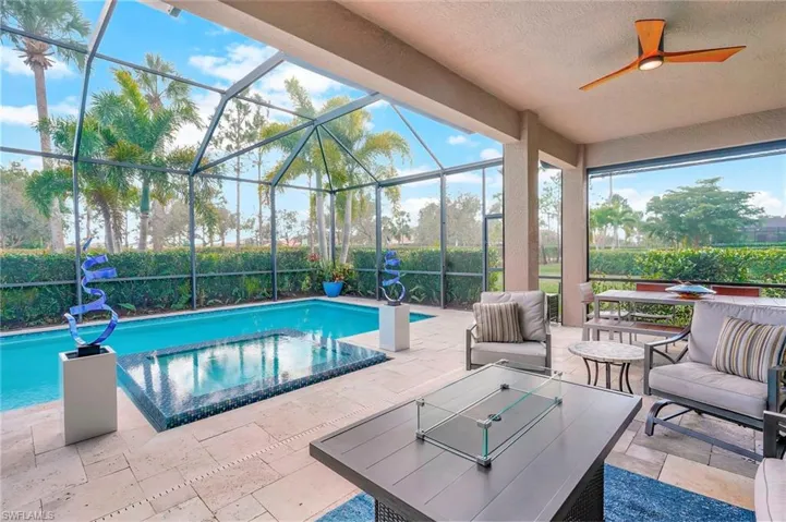 View of pool featuring an outdoor living space, a patio, a lanai, and ceiling fan