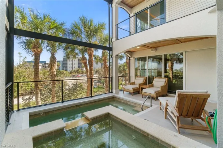 Unfurnished sunroom featuring a jacuzzi