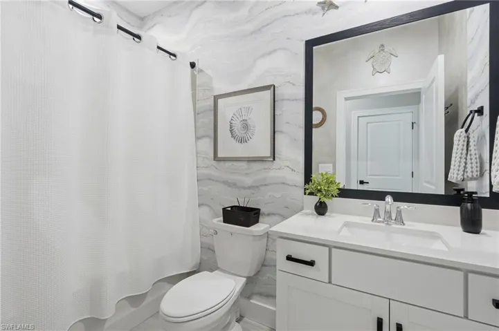 Spa-inspired bathroom featuring a floating vanity with white quartz countertop, polished chrome faucet, and ample storage