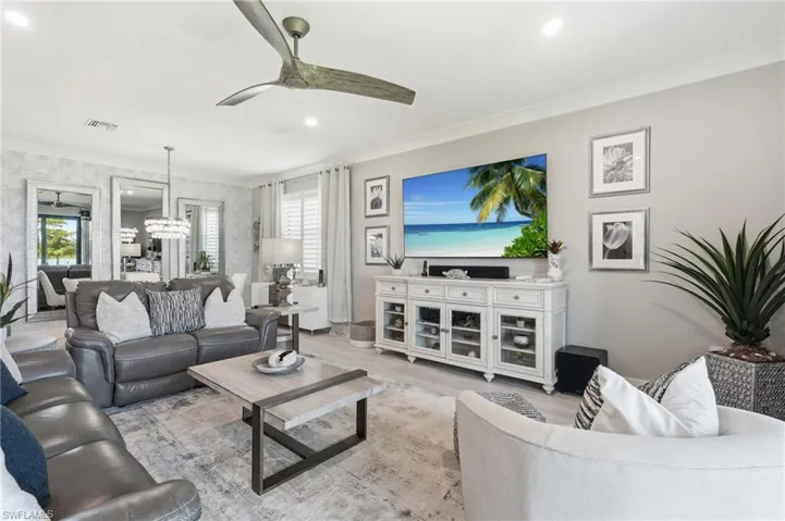Bright, open-concept living area featuring a ceiling fan, recessed lighting, and neutral wall finishes