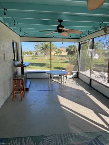 Unfurnished sunroom with ceiling fan