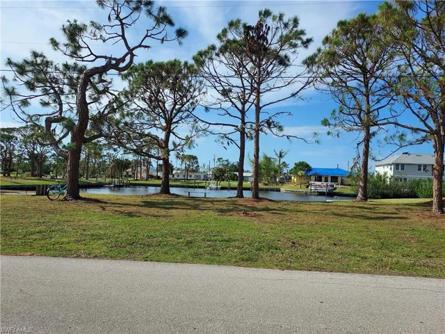 View of home's community featuring a lawn and a water view