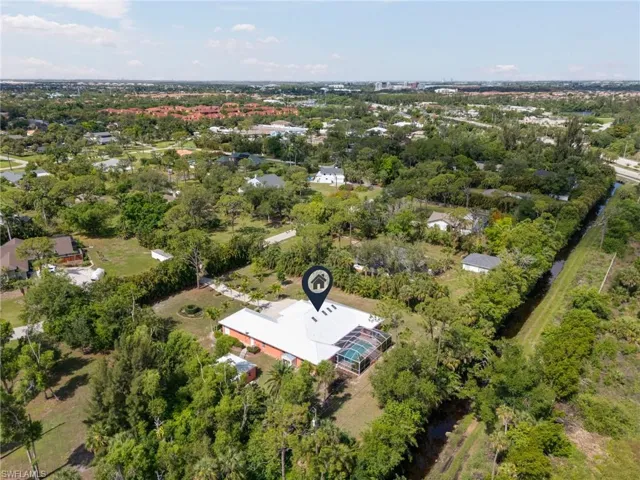 Aerial view of property's location with a tree filled landscape