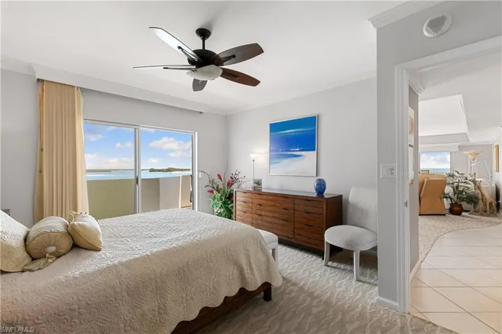 Spacious primary bedroom with sliders to the wrap around lanai