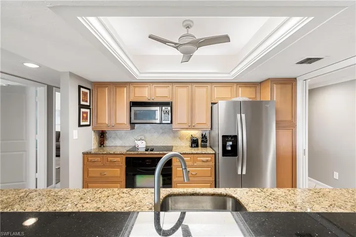 Wood grain cabinetry and granite countertops.