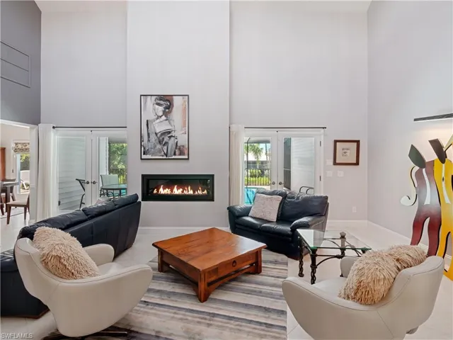 Living room featuring a high ceiling and french doors