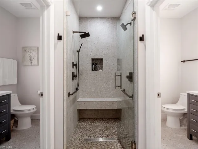 Bathroom featuring tile patterned floors, toilet, and vanity