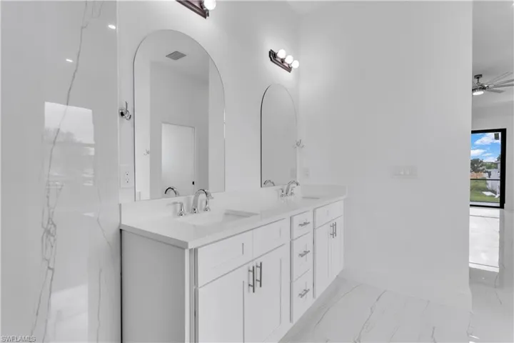 Bathroom with vanity and ceiling fan