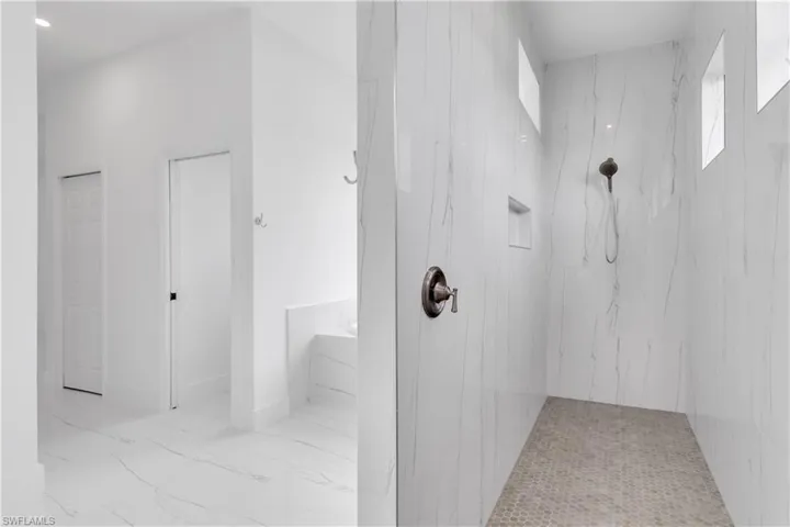 Bathroom featuring tiled shower