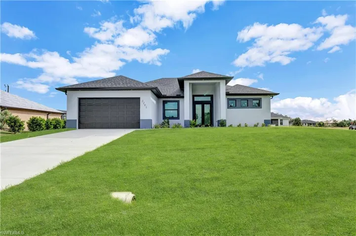 Prairie-style home with a front lawn and a garage