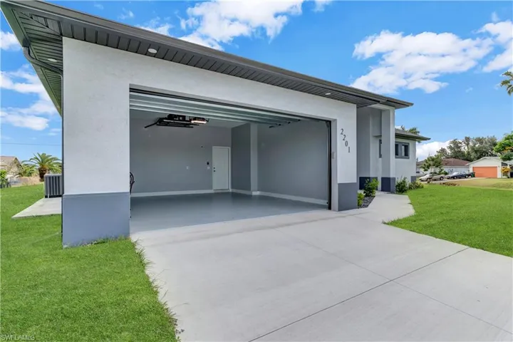 Garage with cooling unit and a lawn