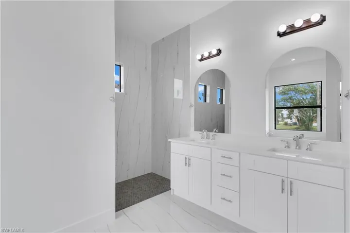 Bathroom featuring vanity and a tile shower