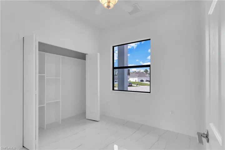 Unfurnished bedroom featuring ceiling fan