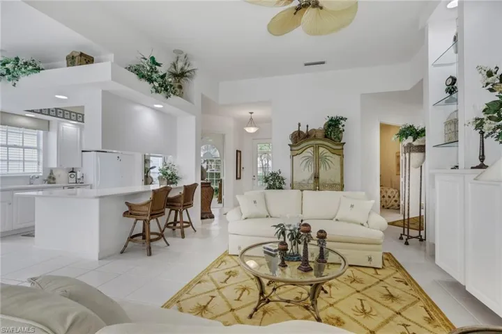 Living room with ceiling fan and recessed lighting