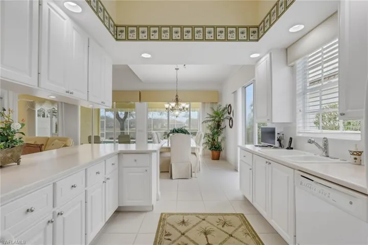Kitchen featuring white cabinets, dishwasher, and plenty of natural light