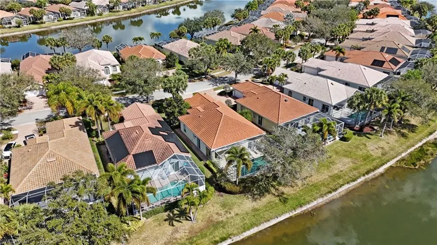 Aerial perspective of suburban area featuring a large body of water