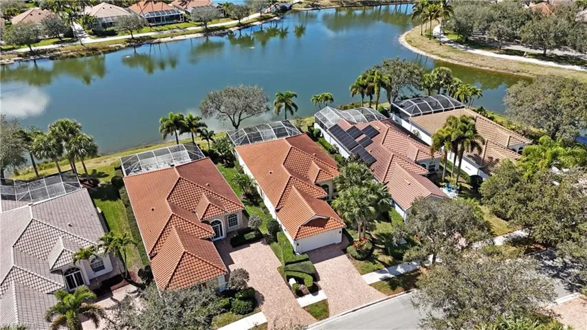Aerial perspective of suburban area featuring a large body of water