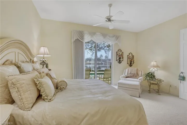Carpeted bedroom featuring access to outside and ceiling fan