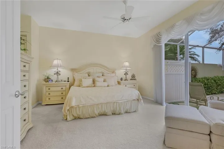 Carpeted bedroom with access to exterior and ceiling fan