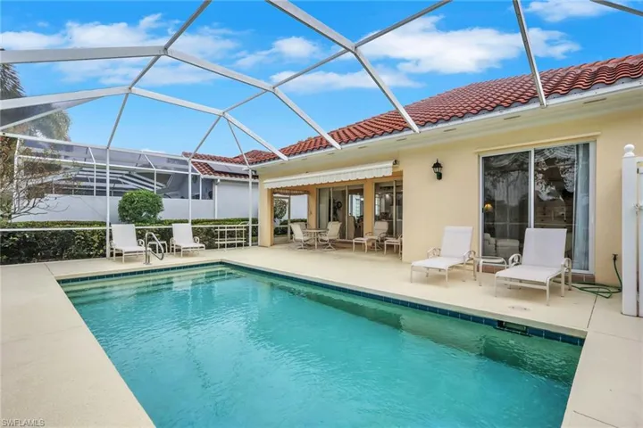 Outdoor pool with a sunroom, a lanai, and a patio area