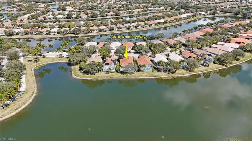 Aerial view of property's location with nearby suburban area and a large body of water