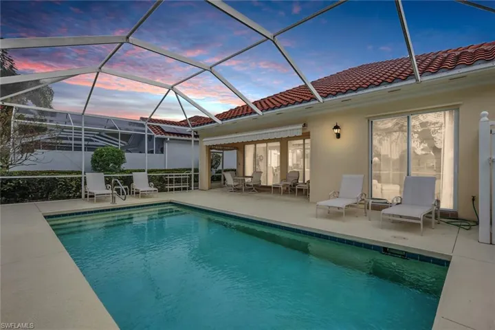 Outdoor pool with a sunroom, a lanai, and a patio area