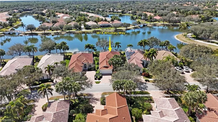 Aerial perspective of suburban area featuring a nearby body of water