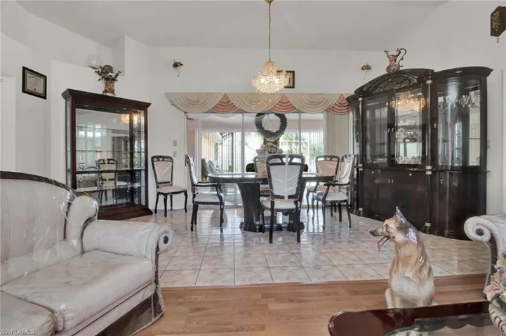 Tiled dining space with a notable chandelier