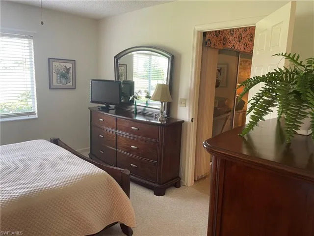Bedroom with light carpet