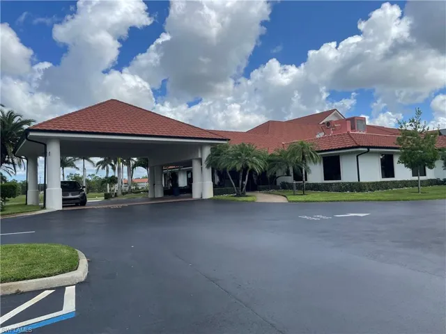 View of property featuring driveway