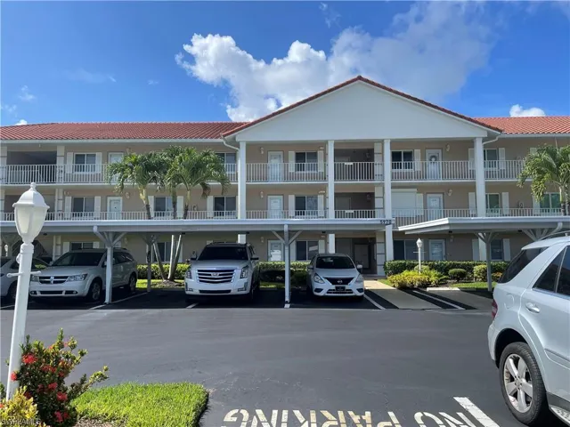 View of property featuring covered parking