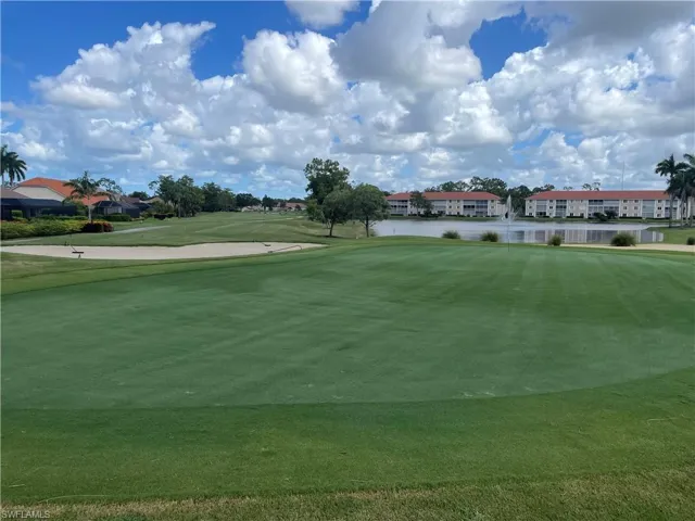 View of community with golf course view and a water view