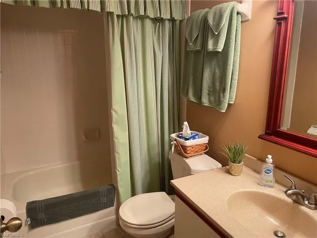 Full bathroom with vanity and shower / bath combination with curtain