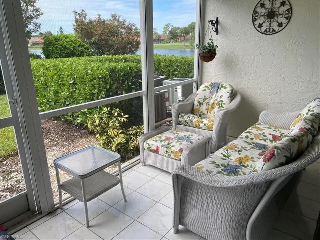 Sunroom / solarium with a water view and healthy amount of natural light
