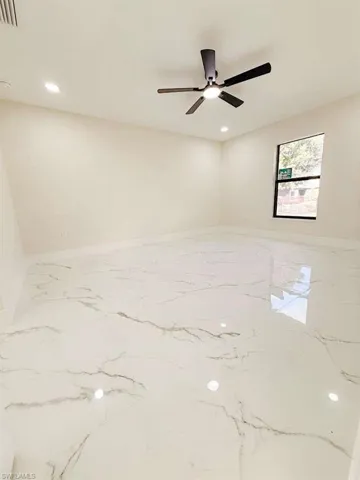 Unfurnished room with recessed lighting, light marble finish flooring, and a ceiling fan